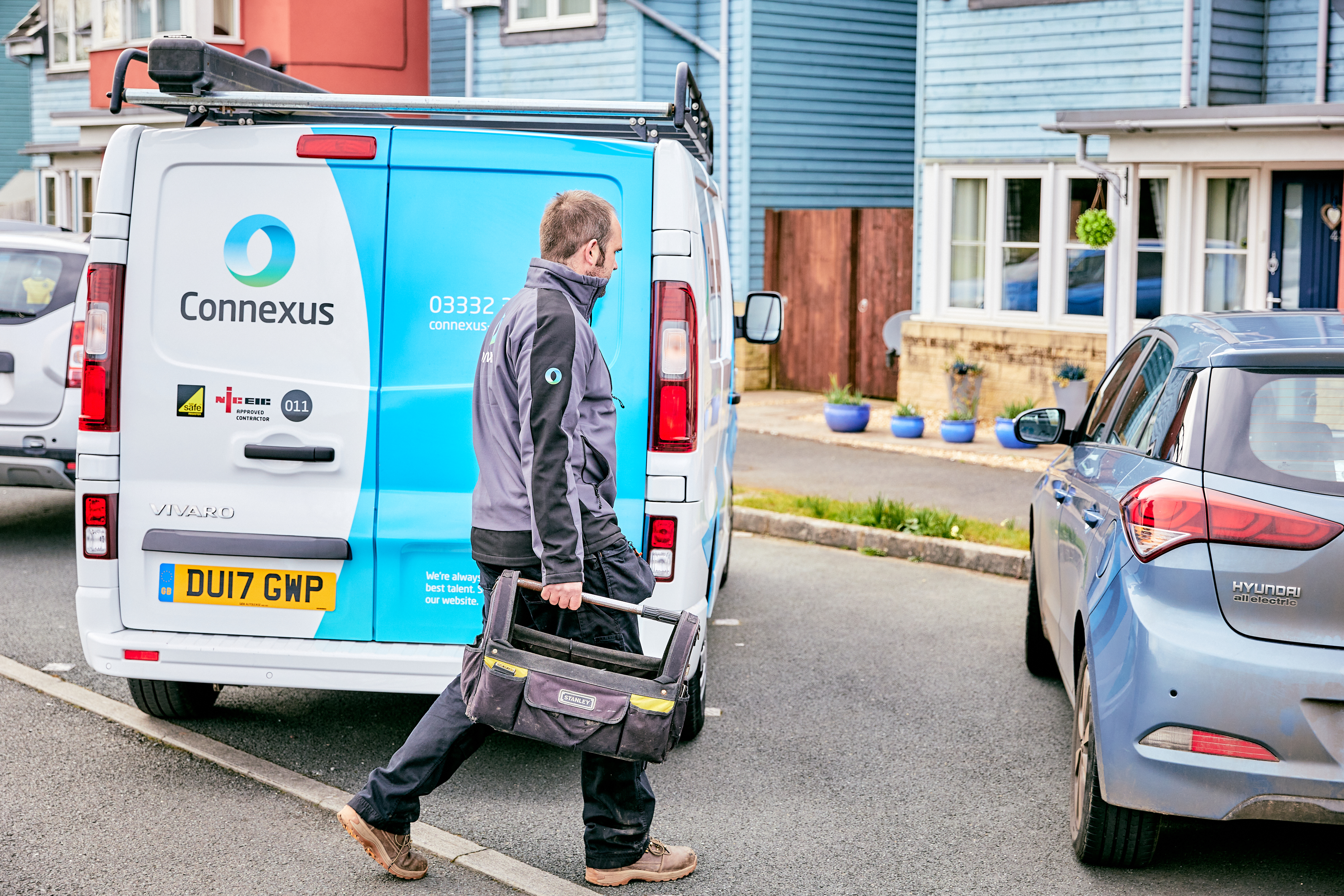 A Connexus trades operative walks past a van