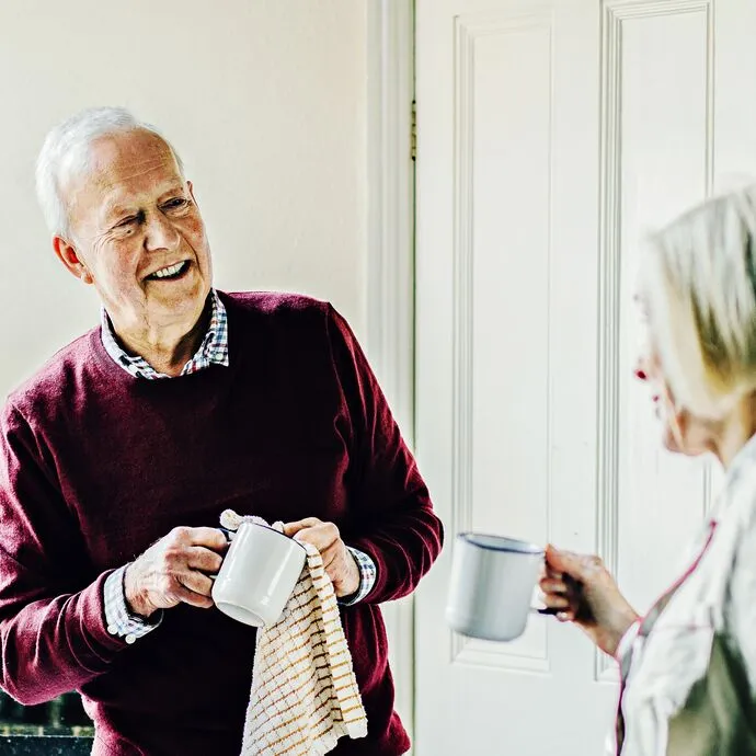 Older man drying a cup