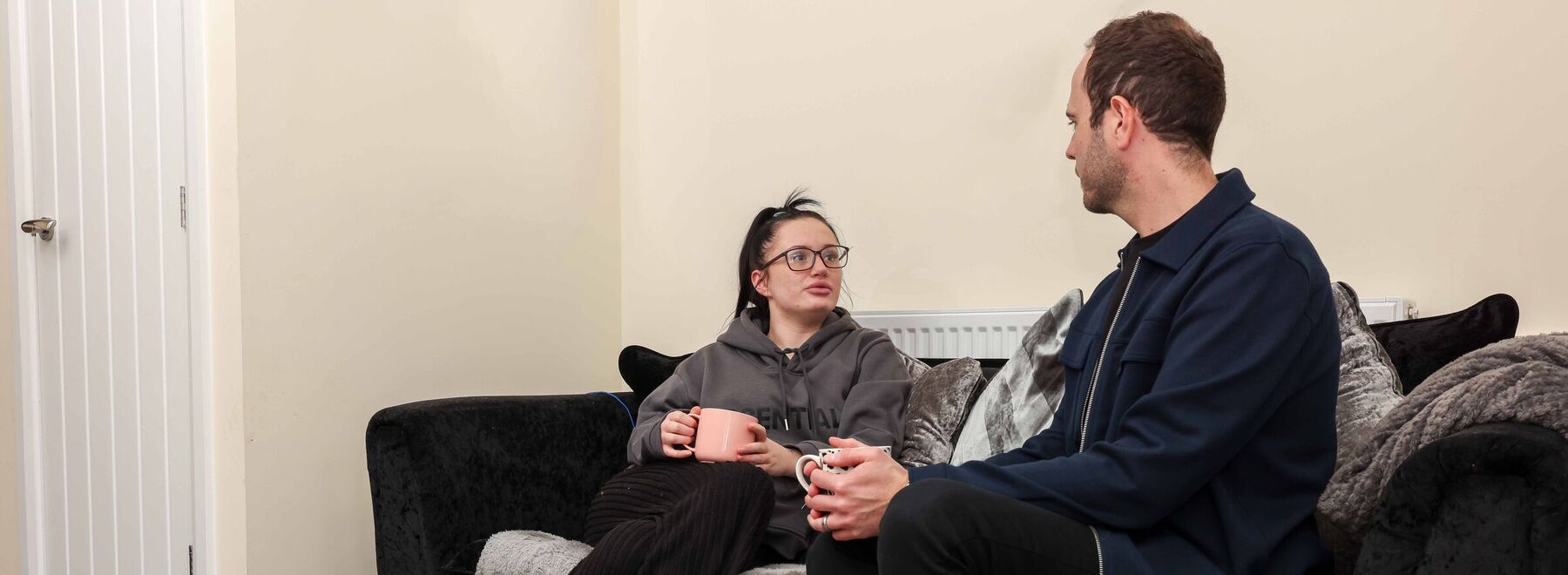 A woman sitting on a sofa talking