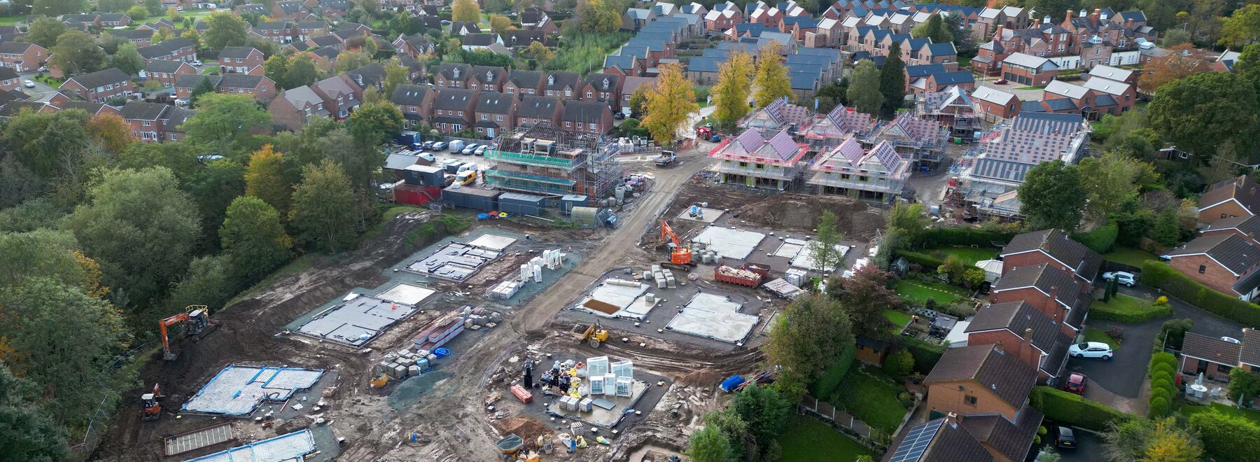 Drone photo of building site with some completed homes and some homes under construction 