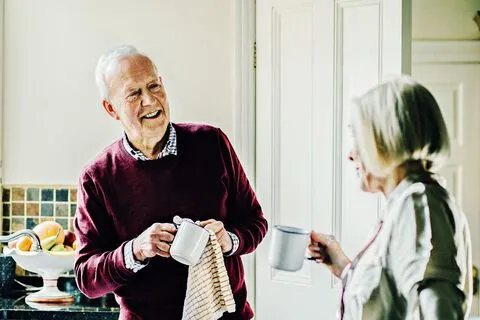 Older man drying a cup