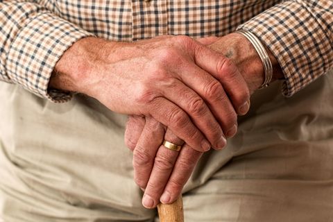 Older man holding walking stick