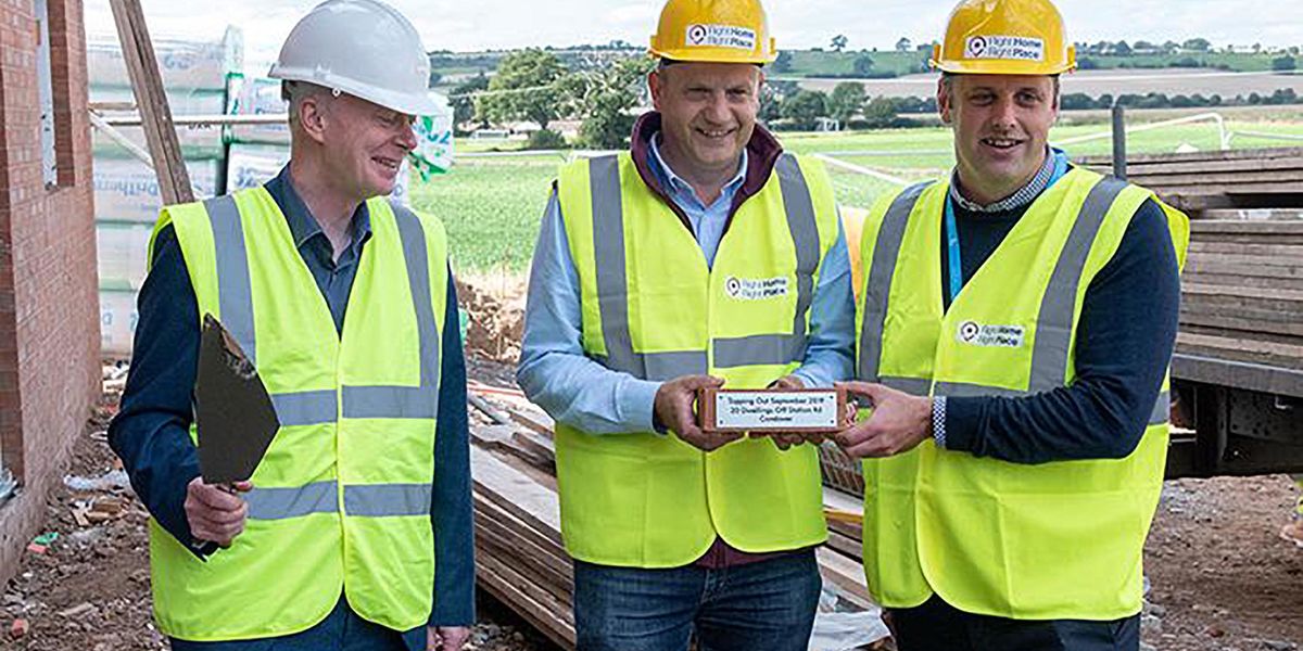 Three men in high vis & hardhats