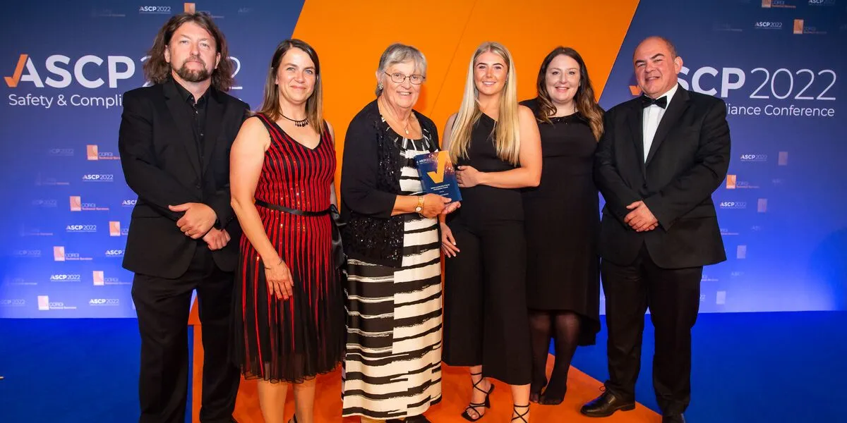 Representatives from Connexus collect a health and safety award on stage in 2022