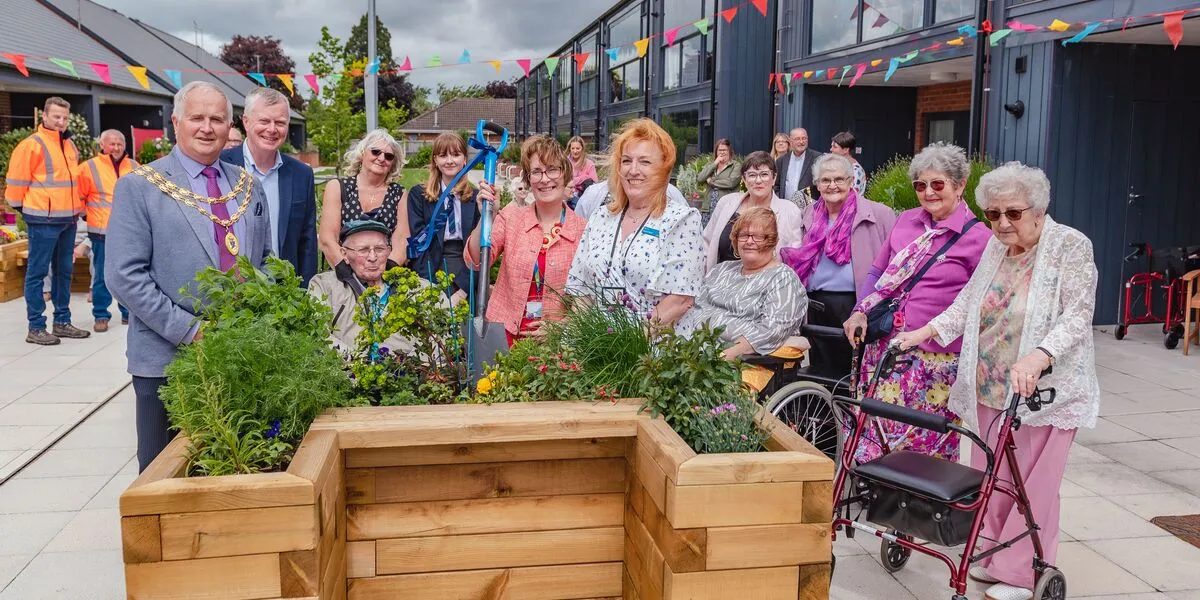 Richard with the Connexus team, customers and Councillor Peter Broomhall, Mayor of Wem at a garden opening at the Westlands scheme, Wem.