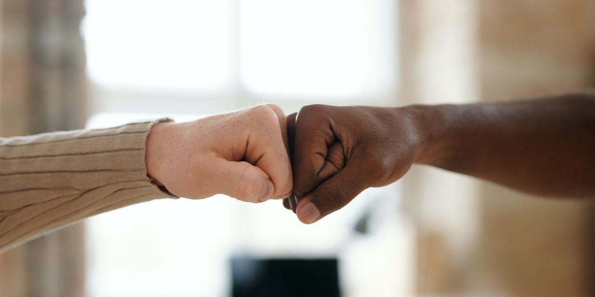 Two people fist bumping in agreement