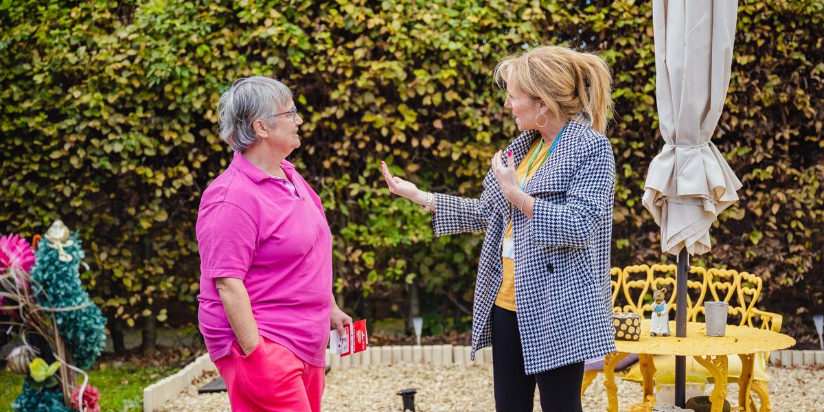 Sian talking to a female Connexus customer in her garden.