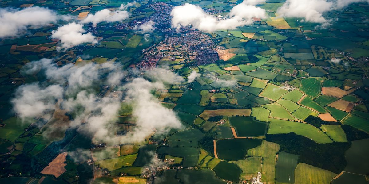 Aerial view of clouds, fields and small towns