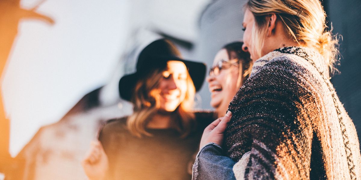 3 women laughing and chatting