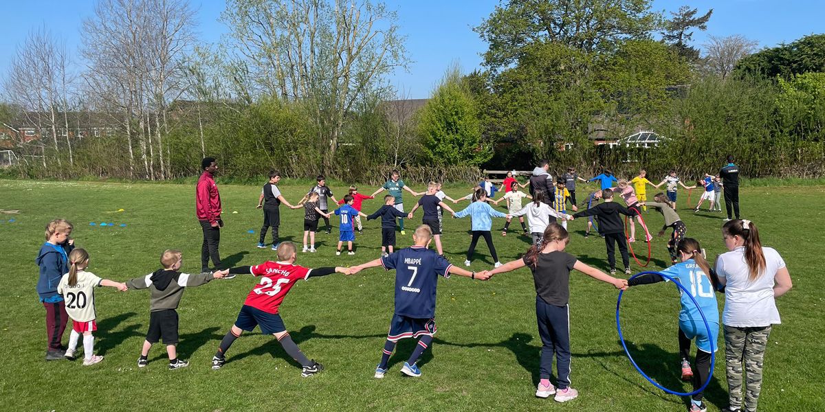 Coaches from The New Saints FC, Ellesmere, Shropshire, supervise children's outdoor activities