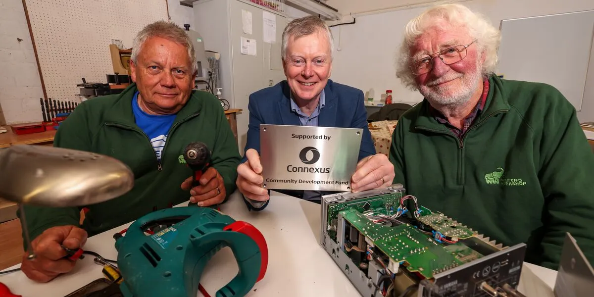 Richard Woolley and workshop volunteers are presented with a plaque