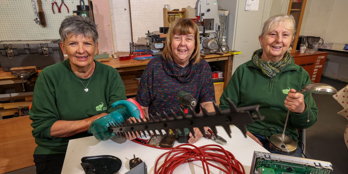 Connexus colleagues and workshop members pose with a mended hedge trimmer 