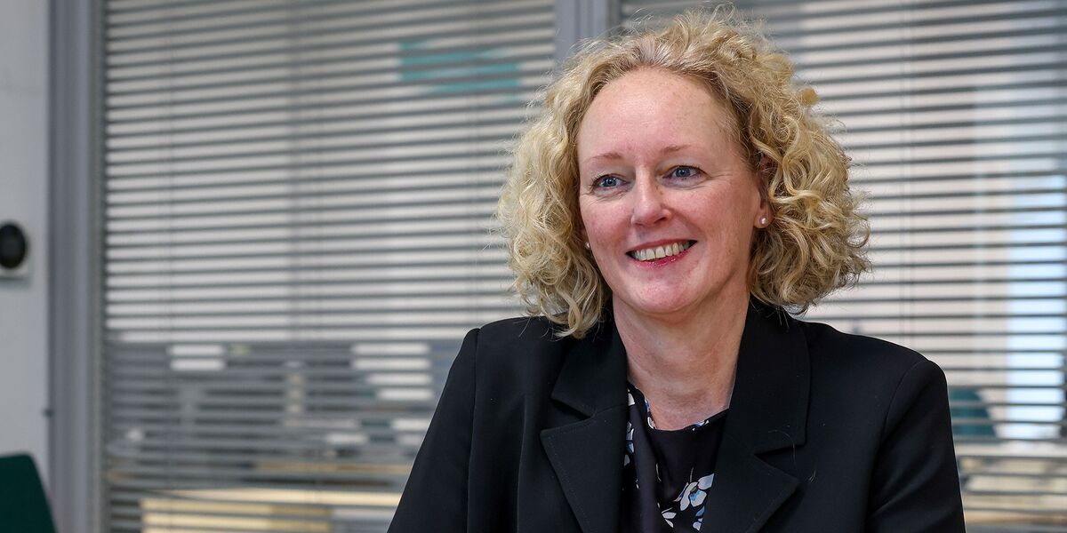 Kate Smith sat at desk at Connexus head office