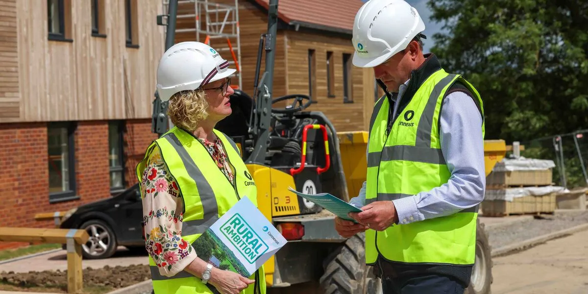 Kate and Stuart talking about Rural Ambition with heavy machinery in the background