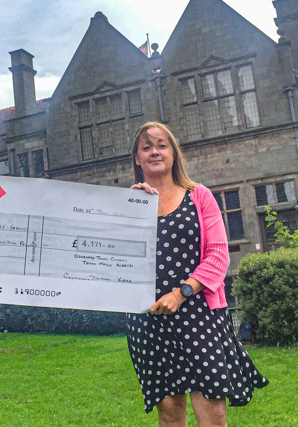 Oswestry Mayor Cllr Duncan Kerr present a cheque to Wendy Bulman, Domestic Abuse Support Service Manager