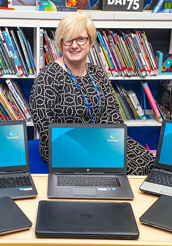 Alison Benge (Head of School, Mount Pleasant Primary) with computers donated by Connexus