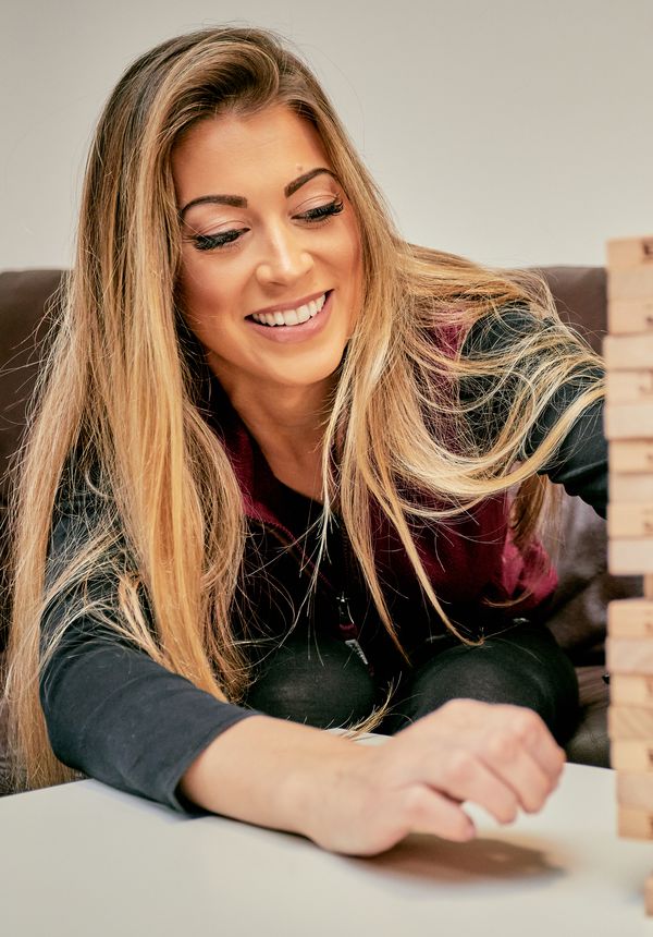 Two people playing Jenga at the Young Persons Service in Ludlow, Shropshire