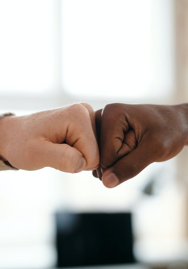 Two people fist bumping in agreement