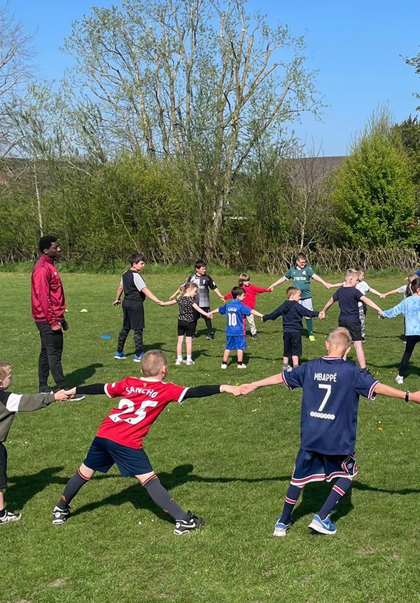 Coaches from The New Saints FC, Ellesmere, Shropshire, supervise children's outdoor activities