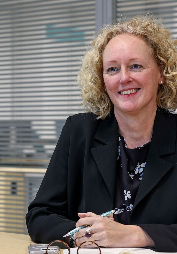 Kate Smith sat at desk at Connexus head office