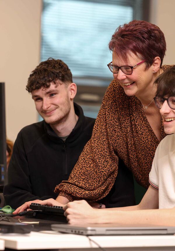 Apprentices looking at computer