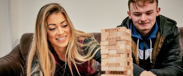 Two people playing Jenga at the Young Persons Service in Ludlow, Shropshire
