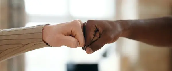 Two people fist bumping in agreement