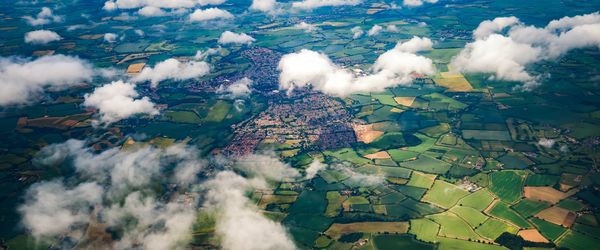 Aerial view of clouds, fields and small towns
