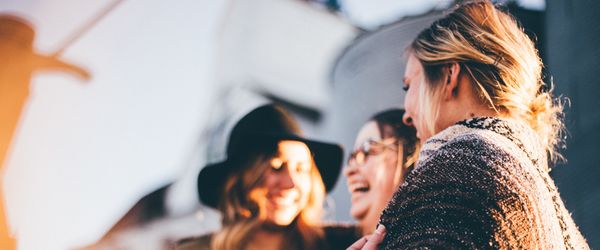 3 women laughing and chatting