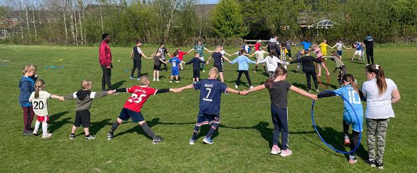 Coaches from The New Saints FC, Ellesmere, Shropshire, supervise children's outdoor activities