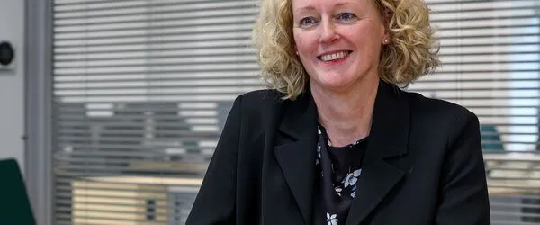 Kate Smith sat at desk at Connexus head office 