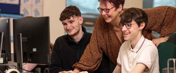 Apprentices looking at computer