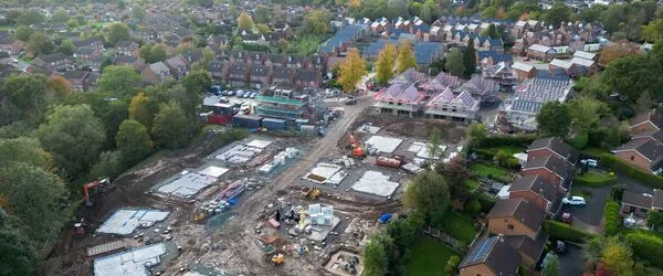 Drone photo of building site with some completed homes and some homes under construction 