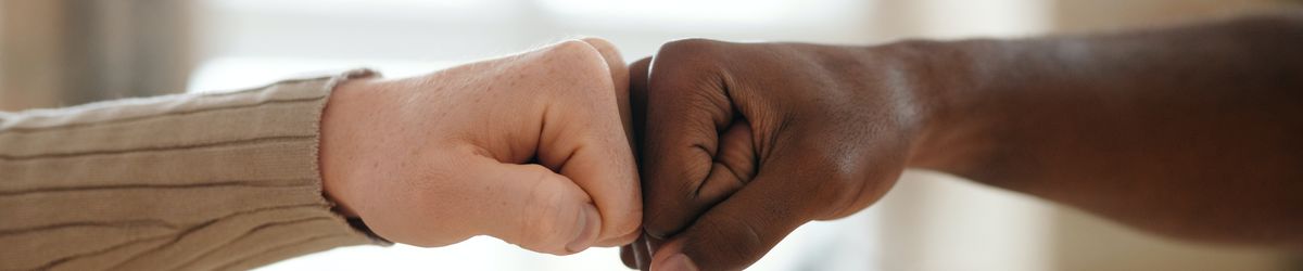 Two people fist bumping in agreement