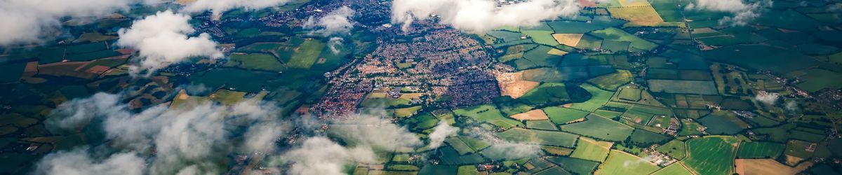 Aerial view of clouds, fields and small towns