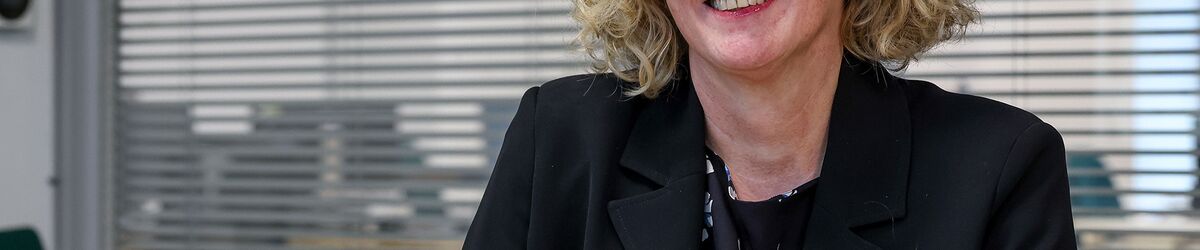 Kate Smith sat at desk at Connexus head office 