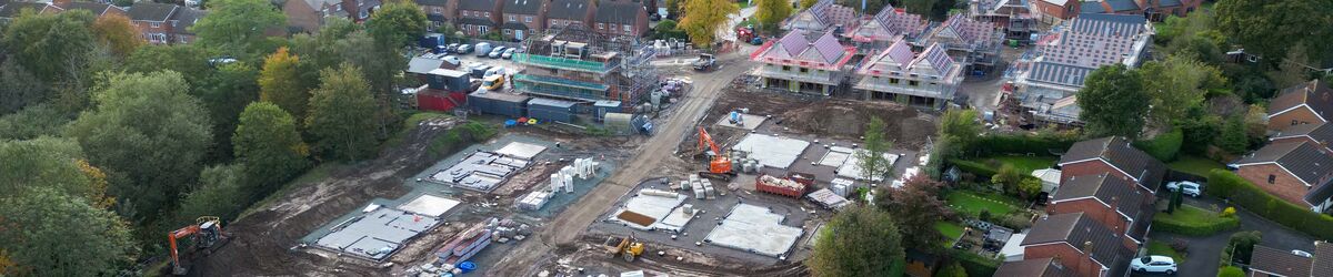 Drone photo of building site with some completed homes and some homes under construction 